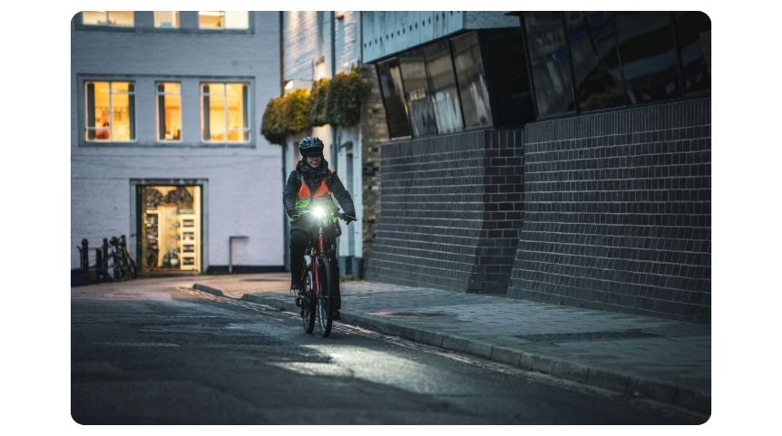 A man biking in a bike lane at night